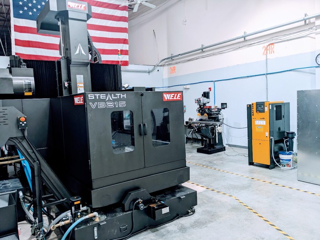 A man working on an industrial machine in a warehouse.